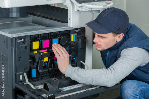 Cuadros en Lienzo young male technician repairing digital photocopier printer machine