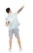 © ghoststone - Back view of a stylish man iin shorts points his hand upwards.