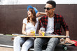 © BalanceFormCreative - Young teen couple sitting on ramp and hangout at the skate park .Laughing and fun.