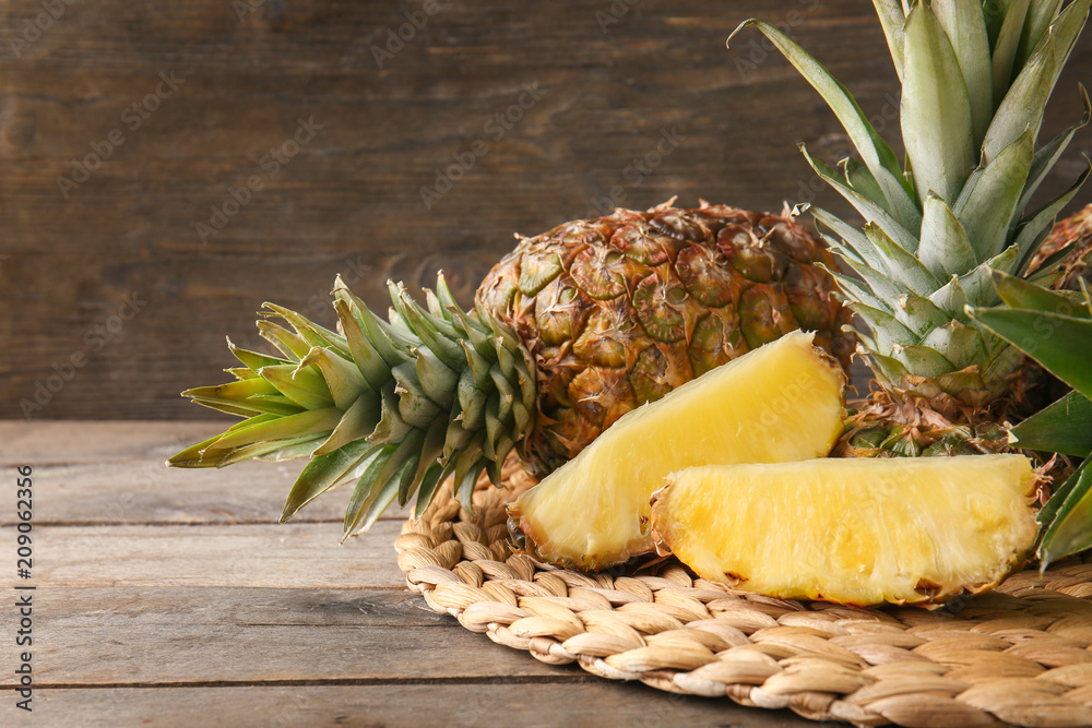 Delicious pineapples on wooden table