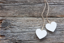 Two White Hearts On Old Wooden Surface