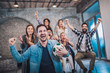 © Mediteraneo - Happy friends or football fans watching soccer on tv and celebrating victory. Friendship, sports and entertainment concept.