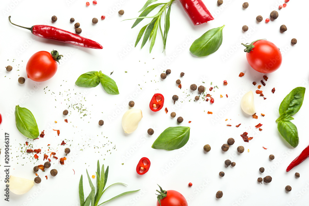 Fresh tomatoes, herbs and spices on white background