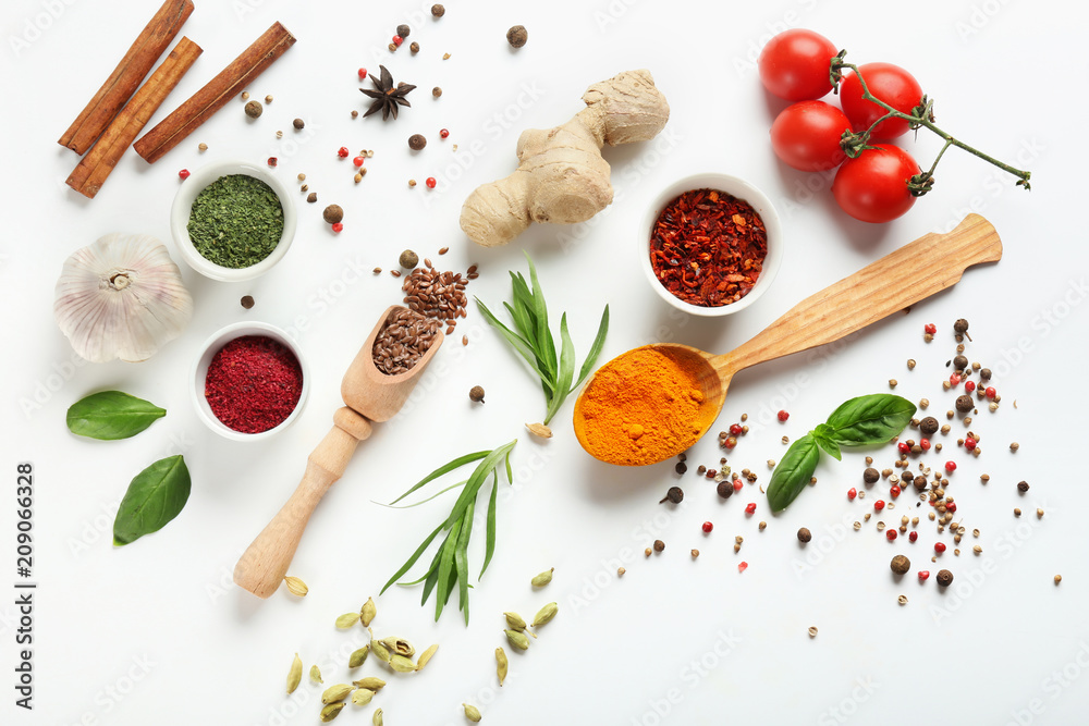 Fresh tomatoes and variety of spices on white background
