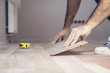 © andrey gonchar - Working with hands installs a laminate board, professional flooring installation