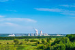 Nuclear power plant with green field and blue sky
