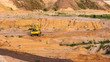 Hydraulic excavator works on sand limestone quarry, industrial heavy machinery