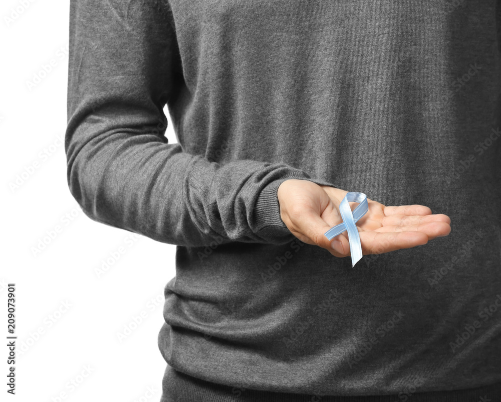 Man holding blue ribbon on white background, closeup. Prostate cancer concept