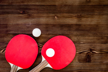 Wall Mural - Red racket for ping pong ball wooden background top view