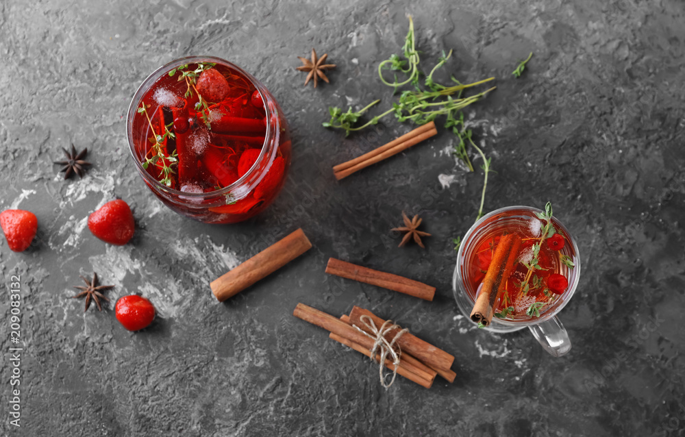 Tasty beverage with berries and cinnamon in glasses on table
