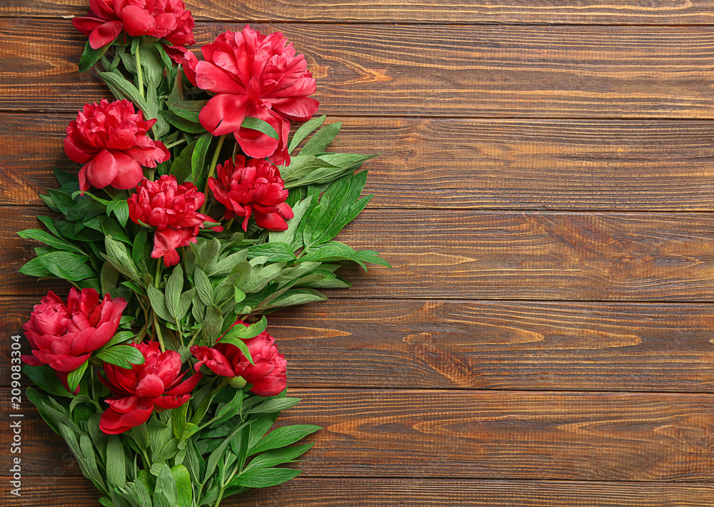 Beautiful peony flowers on wooden background