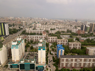 Wall Mural - View from the air on a lot of old and new russian buildings in green area in the city with a lot of cars. Russian streets, Novosibirsk.