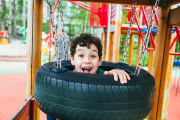 Wall Mural - emotional funny boy in the amusement park. children outdoors. vacation in the summer park