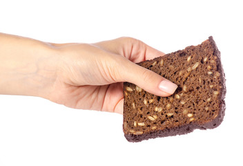 Wall Mural - A piece of bread with seeds in a hand on a white background isolation