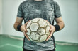 © Westend61 - Close-up of indoor soccer player holding the ball