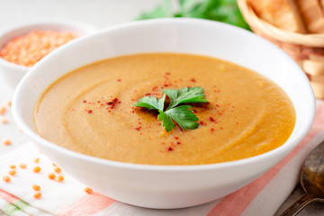 Wall Mural - Red lentil cream soup on gray stone background