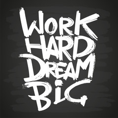 work hard dream big phrase on blackboard