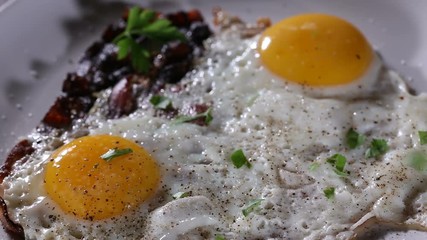 Wall Mural - Sprinkle Chopped Green Parsley Over Fried Eggs And Bacon - Close Up View