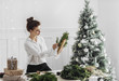 © Lumina/Stocksy - Woman Making A Christmas Wreath