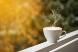 Fototapeta  - Close up white coffee cup with heart shape latte on balcony railing