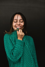 Portrait Of A Happy Girl Wearing Green Knitted Sweater.
