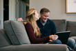 © Sean Locke/Stocksy - Home: Father And Daughter Laugh While Using Laptop