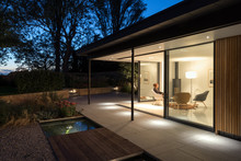 External Picture Of Large Glass Doors Of A Garden Room At Night.