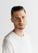 © jessemorrow/Stocksy - Head shot portrait of young adult male with short hair wearing white t-shirt in studio