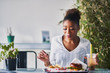 © Joshua Resnick - african american woman sitting down to enjoy healthy vegan fast food