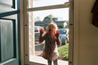 © Maria Manco/Stocksy - little girl presses face against screen door