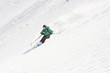 © RGBImages/Stocksy - Male skier freeriding downhill steep snow-capped slope