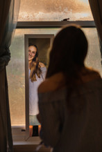 Teen Girl Looking At Herself In The Mirror At Home
