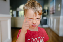 Young Boy With A Funny Expression With His Finger Pointed