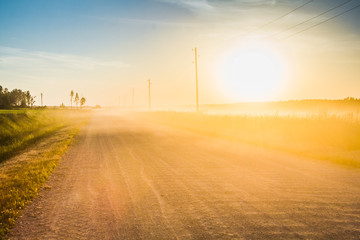 rural dirt road in the light of the sunset, landscape