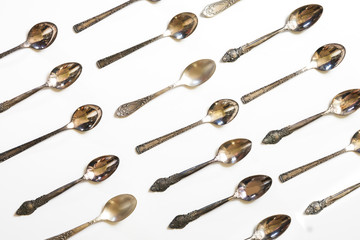 Wall Mural - Vintage spoons, silverware pattern on white background. Kitchen texture. Top view.