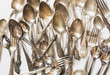 Spoons, forks, knives, silverware pattern on white. Kitchen texture. Top view