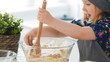 © KONSTANTIN SHISHKIN - Cute little girl mixing the dough for cookies with wooden spoon in glass bowl