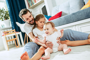 Wall Mural - Proud father holding his newborn baby daughter at home