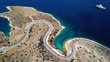 Aerial drone bird's eye view photo of road in Athens riviera seaside known limanakia forming small bays with turquoise clear waters, Vouliagmeni, Attica, Greece