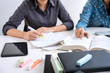 © Freedomz - Education, teaching, learning, technology and people concept. Two high school students or classmates with helps friend catching up workbook learning in classroom, Tutor books with friends