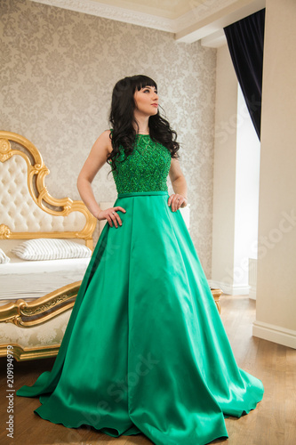 Beautiful Young Girl In A Smart Expensive Emerald Dress In