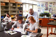 © Monkey Business - High School Students With Tutor Using Microscope In Biology Class