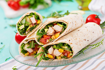 Wall Mural - Burritos wraps with chicken and vegetables on light  background. Chicken burrito, mexican food.