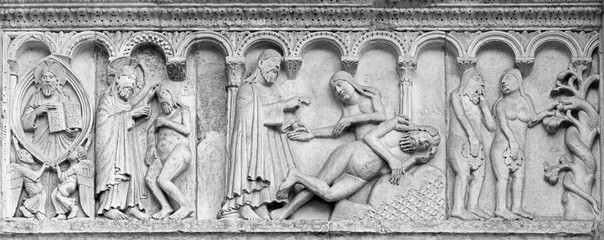 Wall Mural - MODENA, ITALY - APRIL 14, 2018: The romanesque relief of creation of the man and woman on the facade of Duomo di Modena.