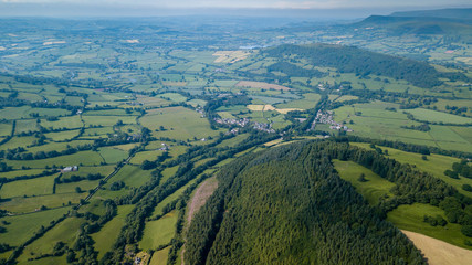 Wall Mural - aerial drone view of rural wales showing farmed fields and green rolling hills