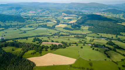 Wall Mural - aerial drone view of rural wales showing farmed fields and green rolling hills