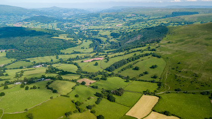 Wall Mural - aerial drone view of rural wales showing farmed fields and green rolling hills