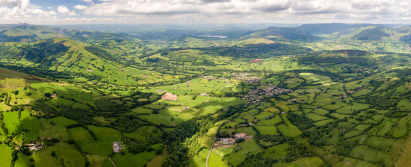 Wall Mural - panoramic aerial view of green farmland and fields in the rural welsh countryside
