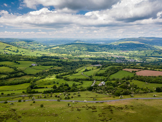 Wall Mural - aerial view of green farmland and fields in the rural welsh countryside