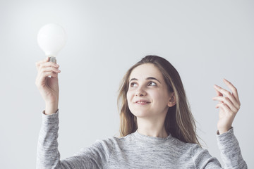 Woman holding a light bulb